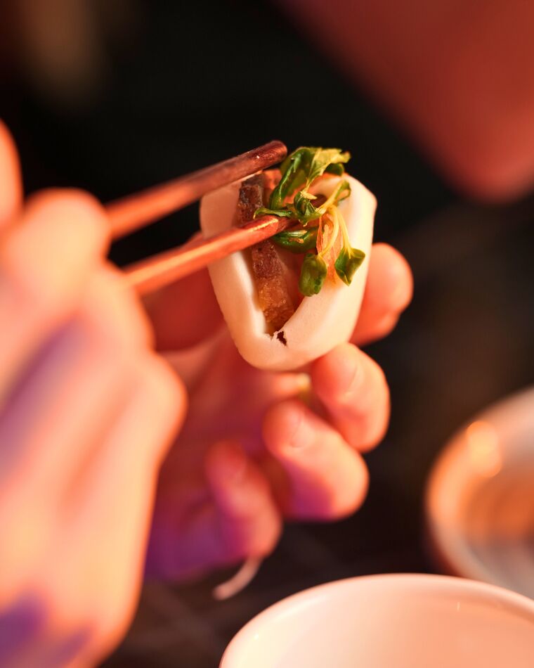 A dumpling lifted fresh from the steamer